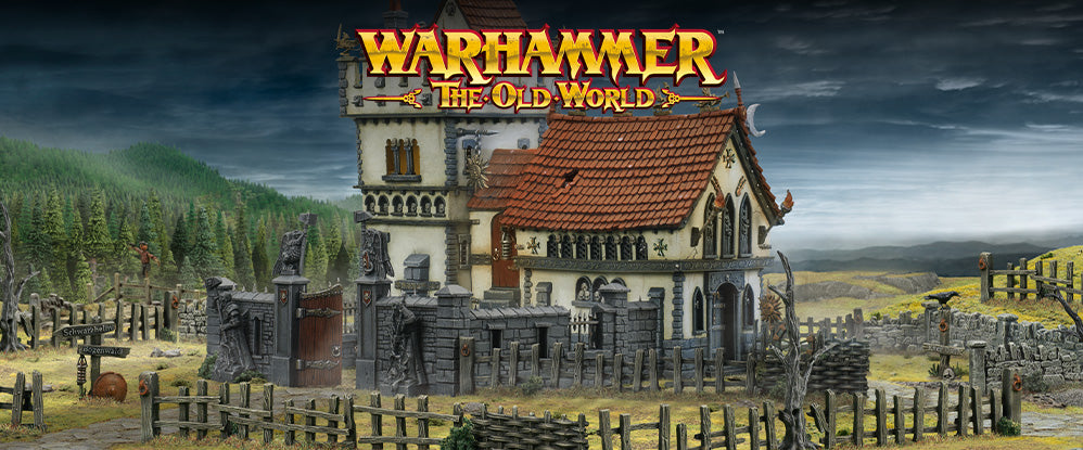 Fantasy village scene from 'Warhammer: The Old World' with a house and graveyard.